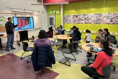 Classroom photo with an ANCHRS presentation running in Alaska